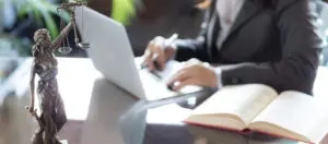 A person is using their laptop at the table