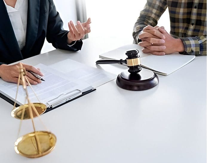 A judge and two other people sitting at a table.